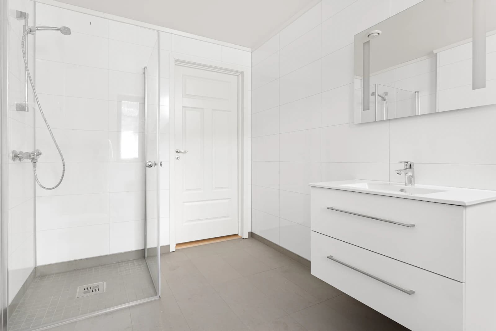 Bright bathroom with clean fittings, tiles and glass