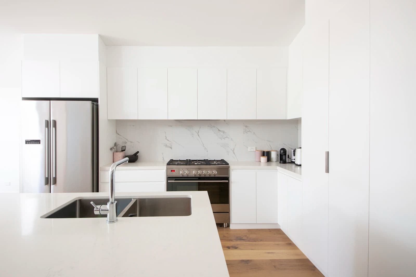 Bright modern kitchen with clear worktops and clean appliances