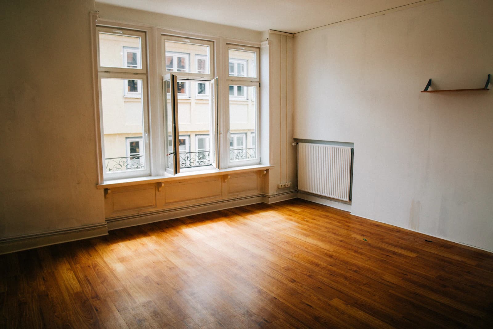 Sunlit empty room with tall clean interior windows